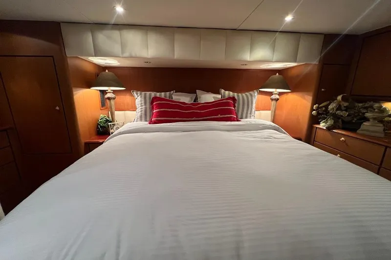 Reel Interest Yacht Photos Pics Luxurious bedroom interior of 2002 Ocean Yachts 56 Super Sport with elegant lighting and decor.