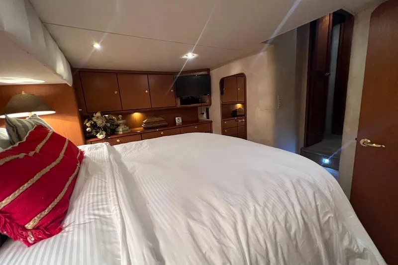 Reel Interest Yacht Photos Pics Luxurious bedroom interior of 2002 Ocean Yachts 56 Super Sport with elegant decor and lighting.