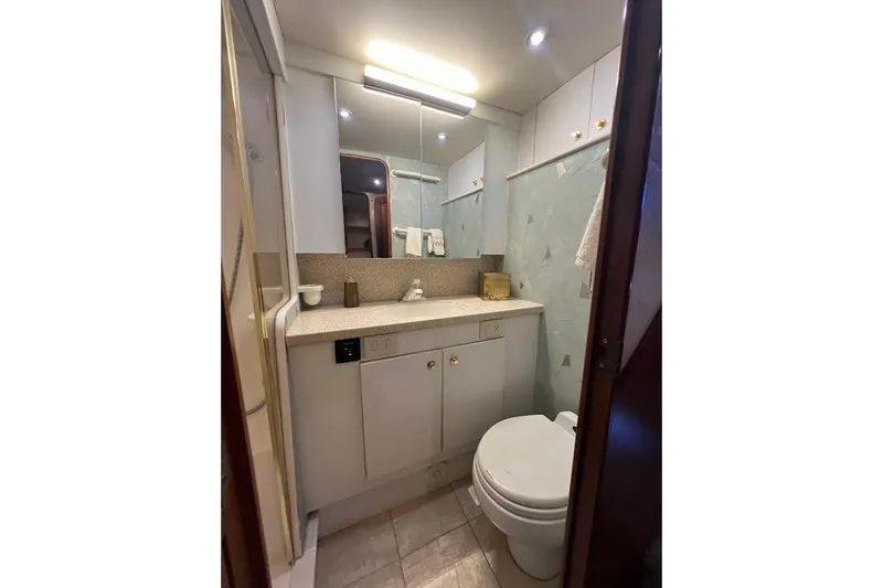 Reel Interest Yacht Photos Pics Luxurious bathroom in 2002 Ocean Yachts 56 Super Sport, featuring modern fixtures and elegant design.