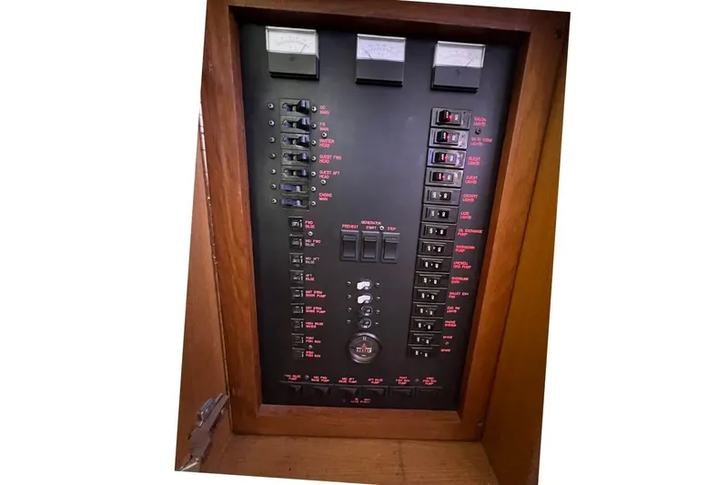 Reel Interest Yacht Photos Pics Electrical panel of a 2002 Ocean Yachts 56 Super Sport boat, featuring switches and gauges.