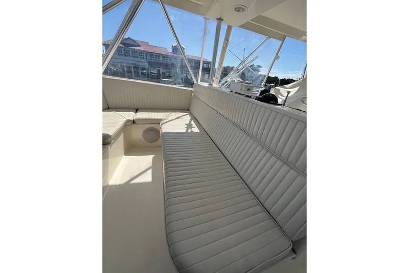 Reel Interest Yacht Photos Pics Interior seating of 2002 Ocean Yachts 56 Super Sport, featuring plush, white upholstery.