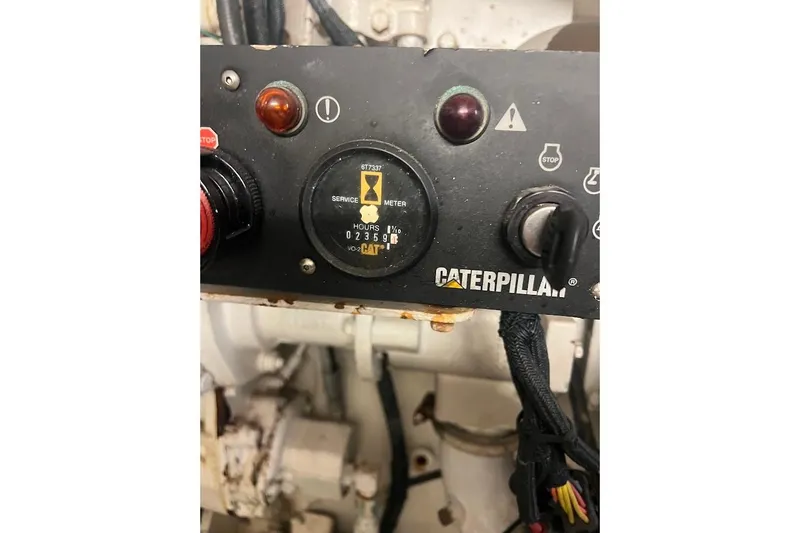 Reel Interest Yacht Photos Pics Caterpillar engine control panel on 2002 Ocean Yachts 56 Super Sport, showing service meter.