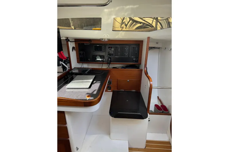 Dark Storm Yacht Photos Pics 2019 J Boats J/121 interior navigation station with control panel and seating.
