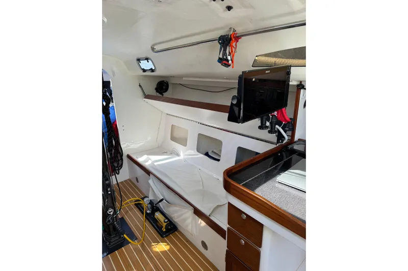 Dark Storm Yacht Photos Pics 2019 J Boats J/121 interior with modern navigation equipment and sleek wooden finishes.