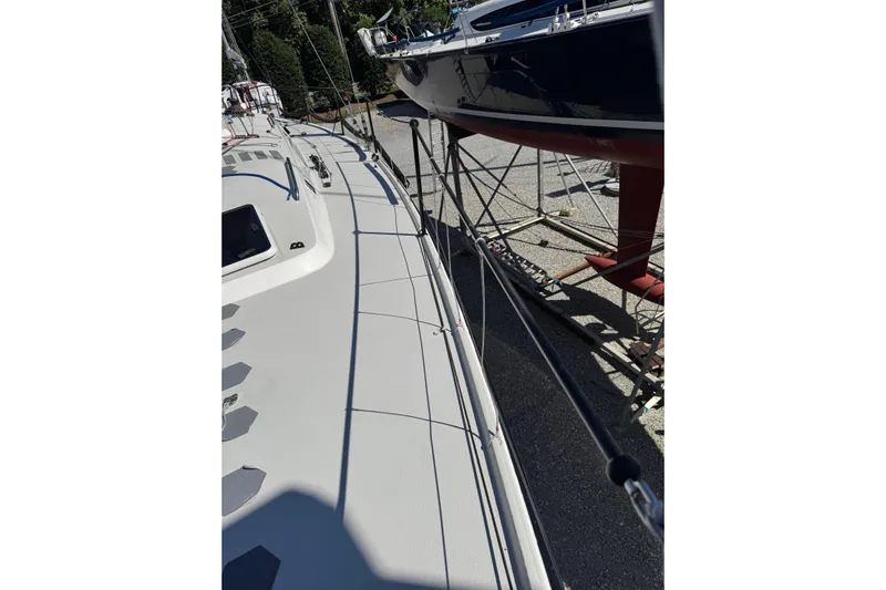 Dark Storm Yacht Photos Pics 2019 J Boats J/121 sailboat on dry dock, showcasing deck and railing details.