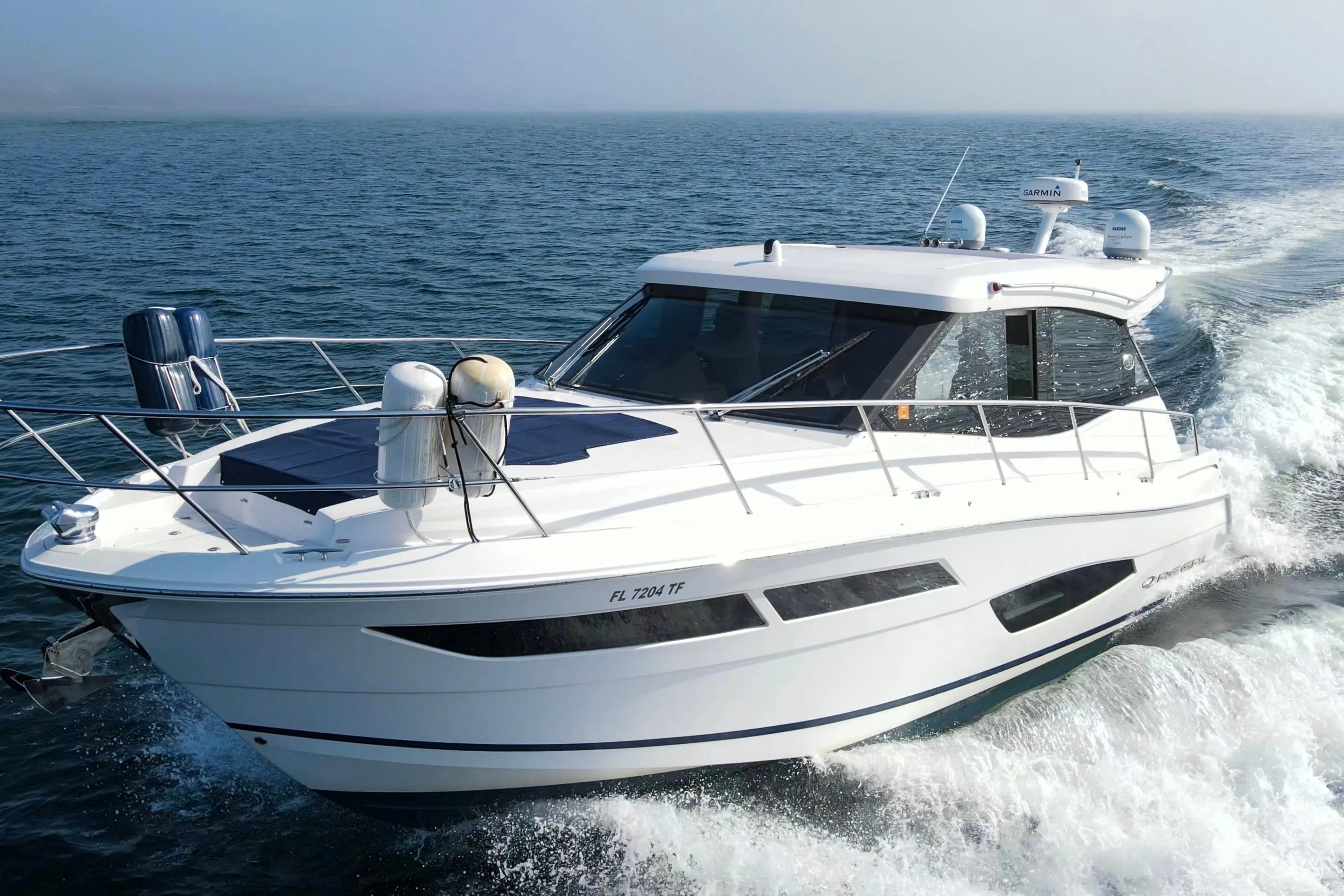 2020 Regal 38 XO yacht cruising on open water, showcasing sleek design and modern features.