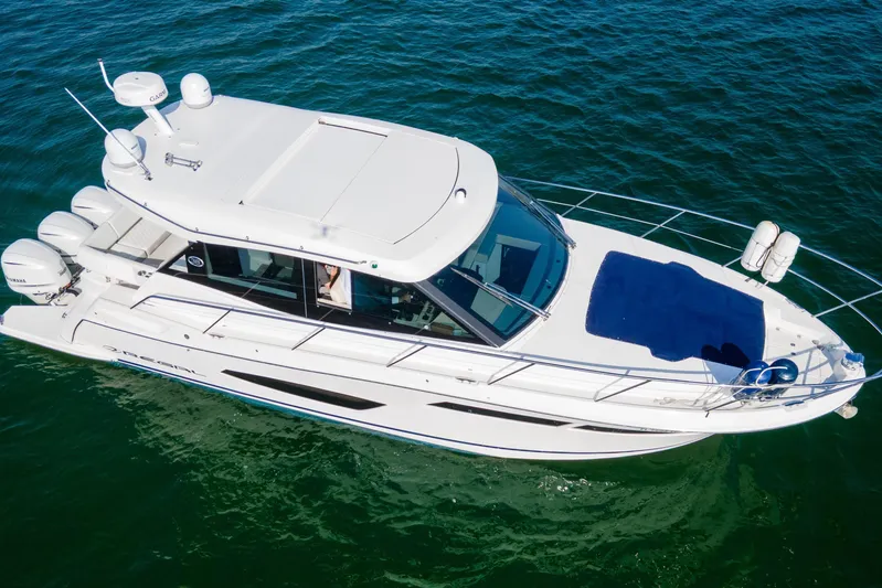  Yacht Photos Pics 2020 Regal 38 XO luxury yacht cruising on clear blue water.