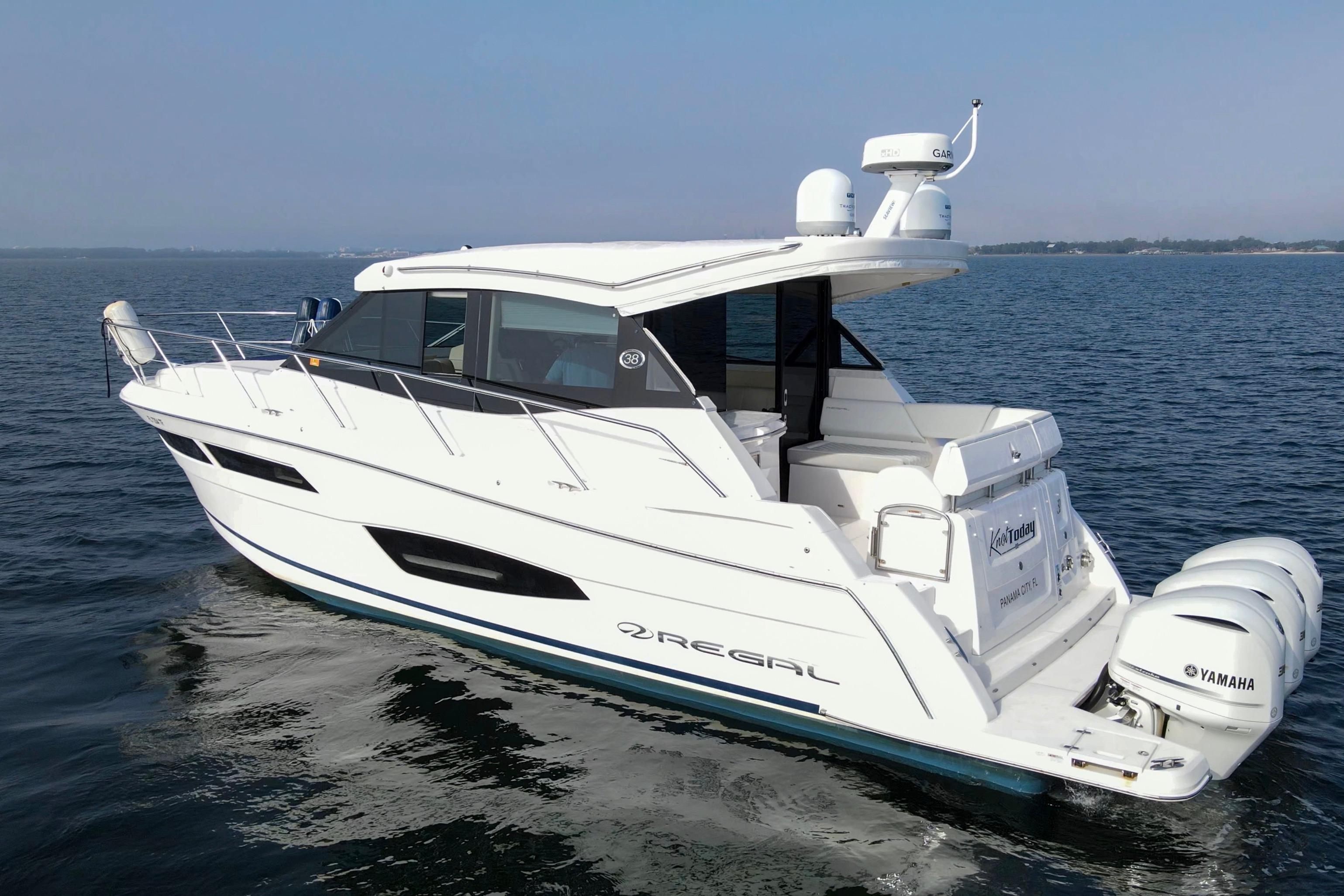 2020 Regal 38 XO yacht cruising on open water with Yamaha engines.