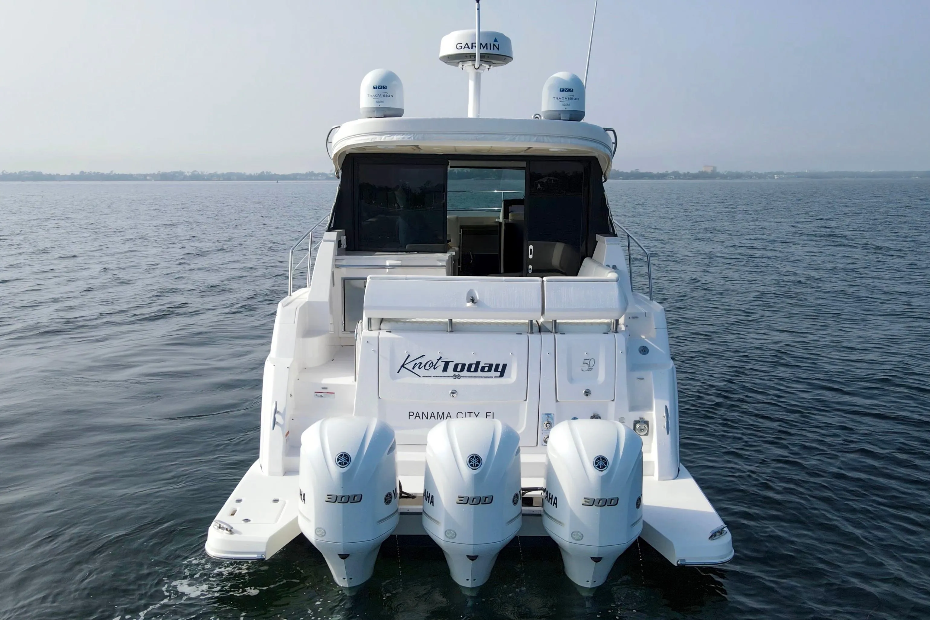 2020 Regal 38 XO yacht with triple Yamaha engines on open water.