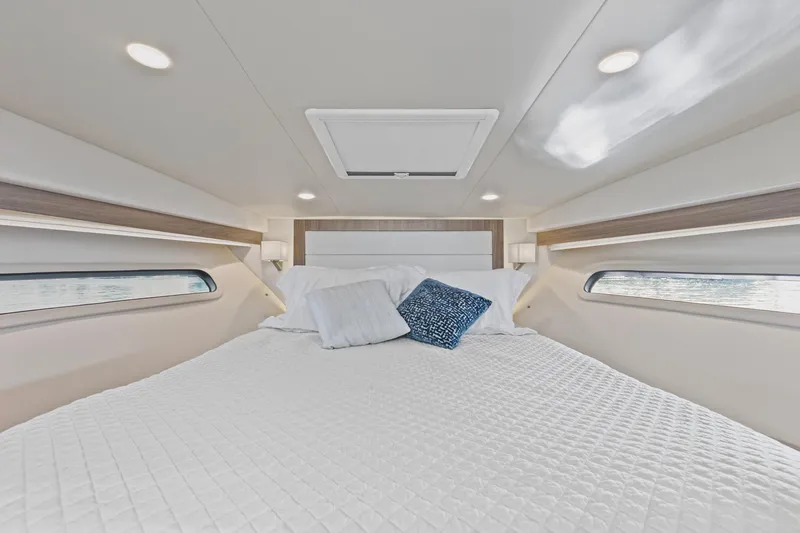  Yacht Photos Pics Luxurious cabin interior of 2020 Regal 38 XO yacht with cozy bedding.
