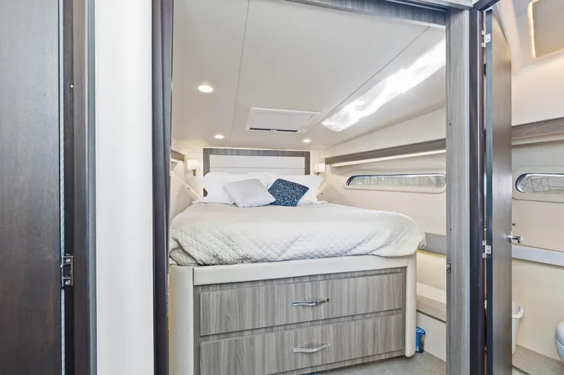  Yacht Photos Pics Luxurious cabin interior of 2020 Regal 38 XO yacht with cozy bed and modern design.