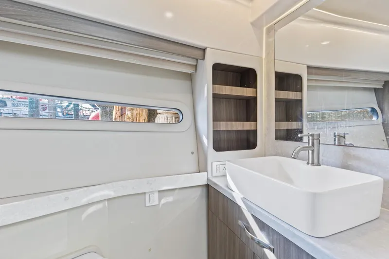  Yacht Photos Pics Modern bathroom interior of 2020 Regal 38 XO yacht with sleek sink and window.