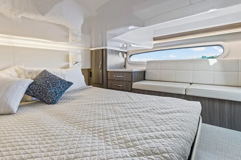  Yacht Photos Pics Luxurious interior of 2020 Regal 38 XO yacht with modern bedding and seating.