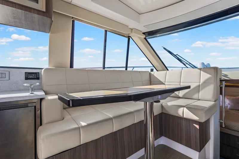  Yacht Photos Pics Luxurious interior of 2020 Regal 38 XO yacht with plush seating and panoramic windows.