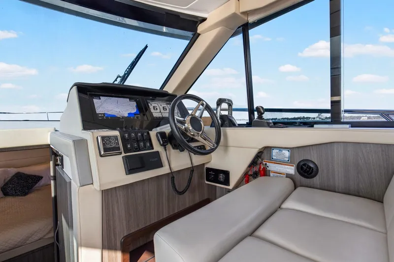  Yacht Photos Pics Helm of 2020 Regal 38 XO yacht with modern navigation system and comfortable seating.