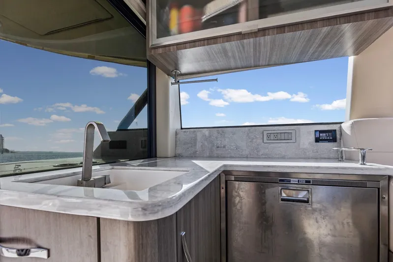  Yacht Photos Pics Modern kitchen area on 2020 Regal 38 XO yacht with sleek design and ocean view.