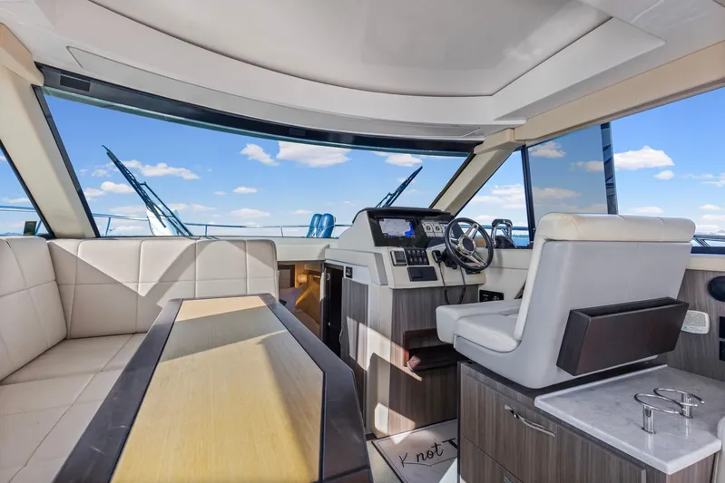  Yacht Photos Pics Interior of 2020 Regal 38 XO yacht with modern helm and seating under blue sky.