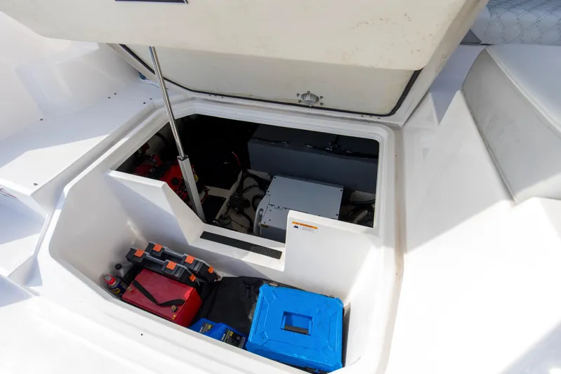 Yacht Photos Pics Open engine compartment of 2020 Regal 38 XO boat, showcasing storage and equipment.