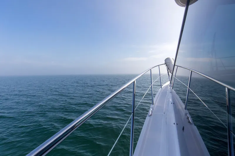  Yacht Photos Pics Bow view of 2020 Regal 38 XO yacht cruising on open sea.