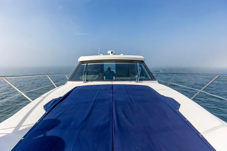  Yacht Photos Pics 2020 Regal 38 XO yacht cruising on open water under clear blue sky.