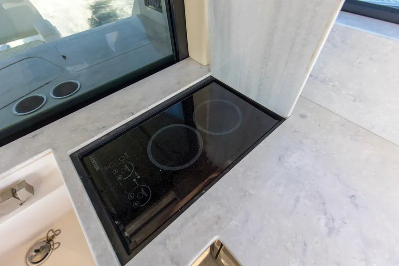  Yacht Photos Pics Modern stovetop on 2020 Regal 38 XO yacht with sleek countertop design.