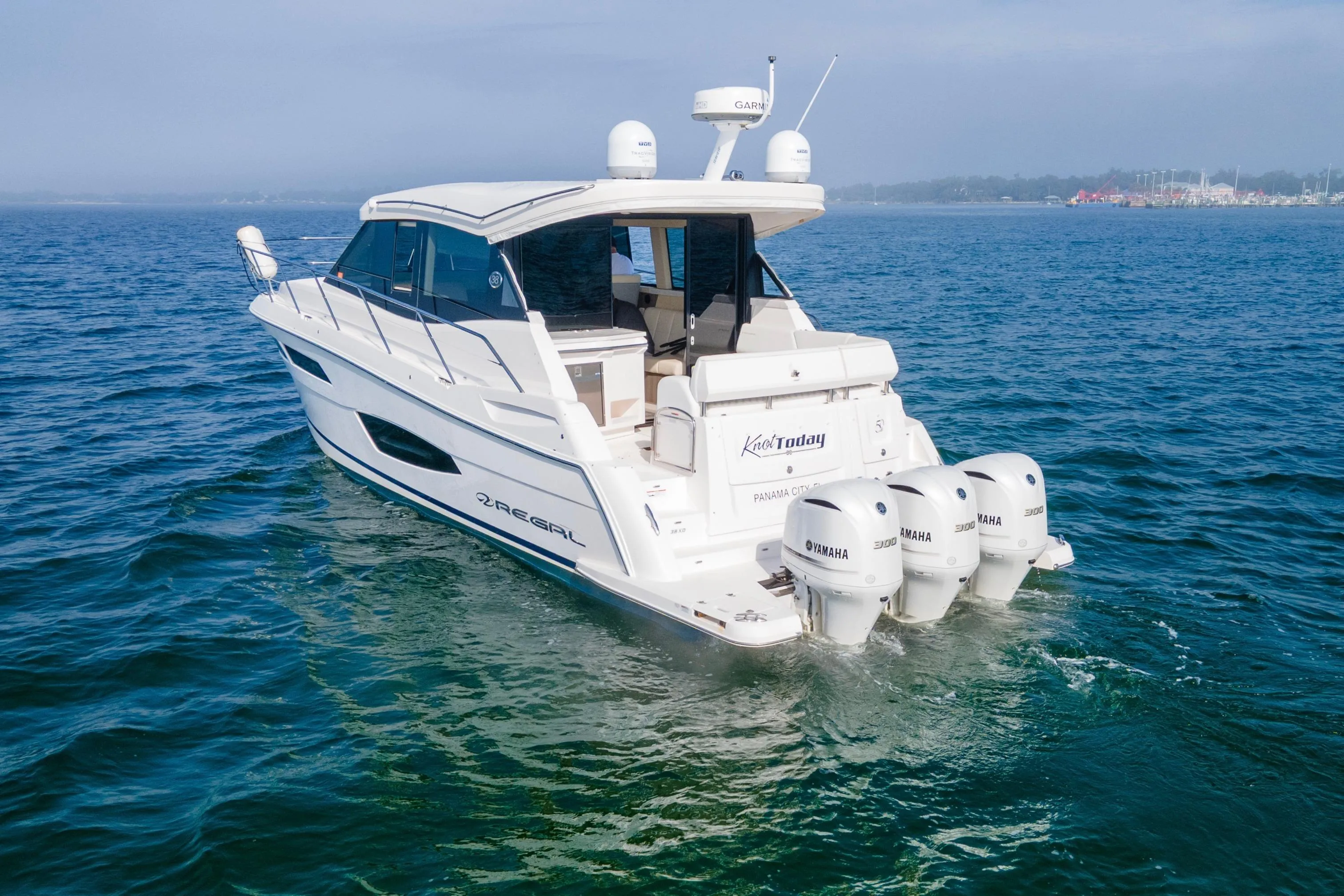 2020 Regal 38 XO boat cruising on open water with Yamaha engines.
