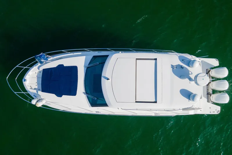  Yacht Photos Pics Aerial view of 2020 Regal 38 XO yacht on green water.