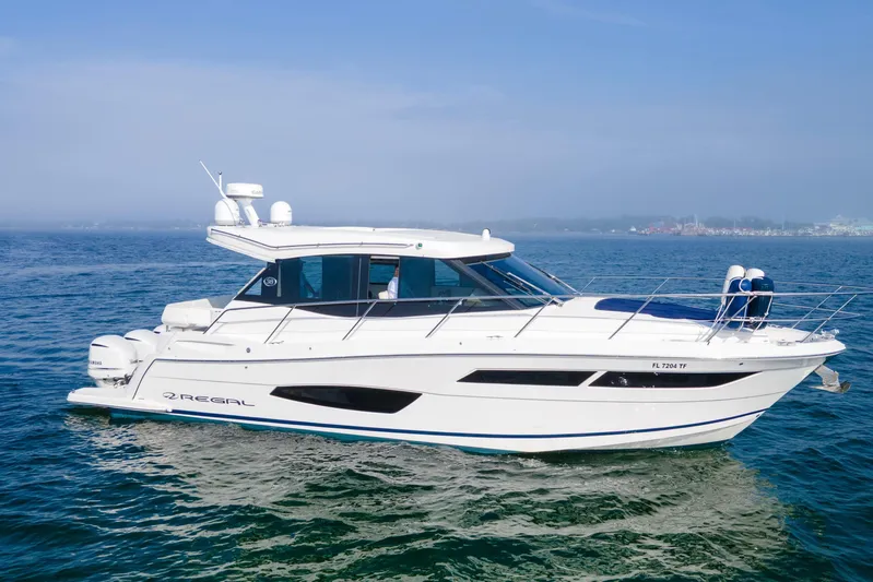  Yacht Photos Pics 2020 Regal 38 XO yacht cruising on open water under clear skies.