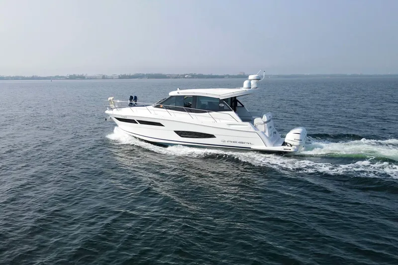  Yacht Photos Pics 2020 Regal 38 XO yacht cruising on open water, side view.