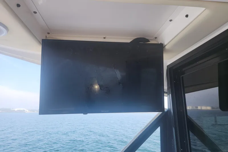  Yacht Photos Pics Flat-screen TV on 2020 Regal 38 XO yacht, overlooking calm ocean waters.