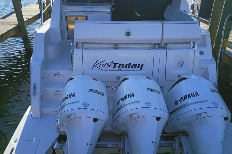  Yacht Photos Pics 2020 Regal 38 XO boat with triple Yamaha 300 engines, docked at a marina.