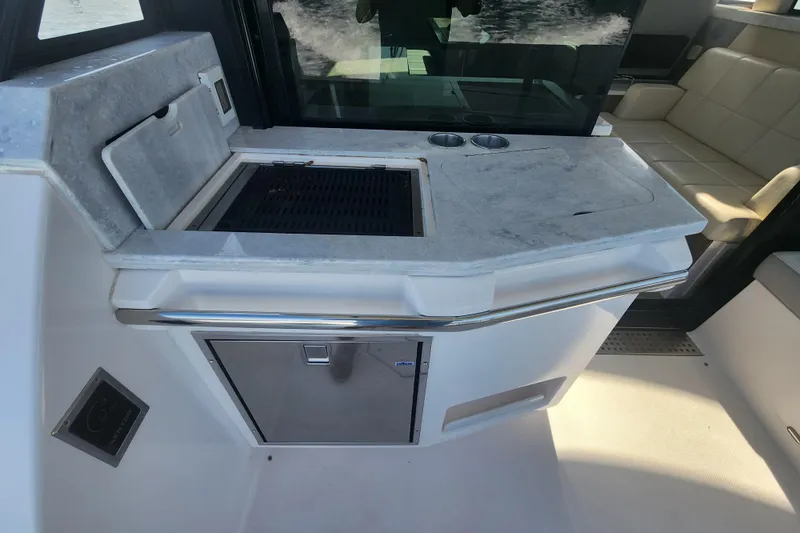  Yacht Photos Pics Outdoor kitchen area on a 2020 Regal 38 XO yacht with grill and seating.