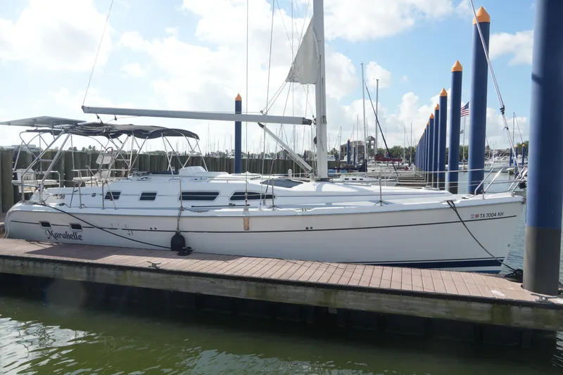 Marabelle Yacht Photos Pics 2005 Hunter 41 AC sailboat docked at marina under clear sky.