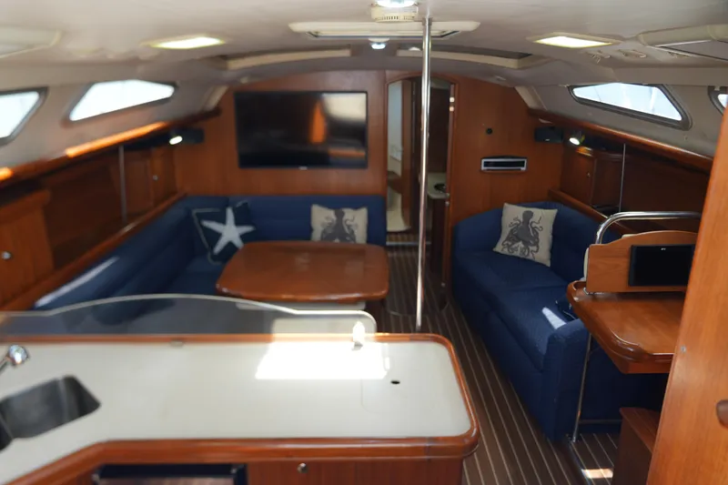 Marabelle Yacht Photos Pics Luxurious interior of 2005 Hunter 41 AC yacht with elegant wood finish and cozy seating.