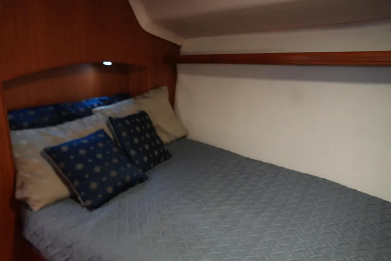 Marabelle Yacht Photos Pics Cozy cabin bed with blue pillows in 2005 Hunter 41 AC yacht.