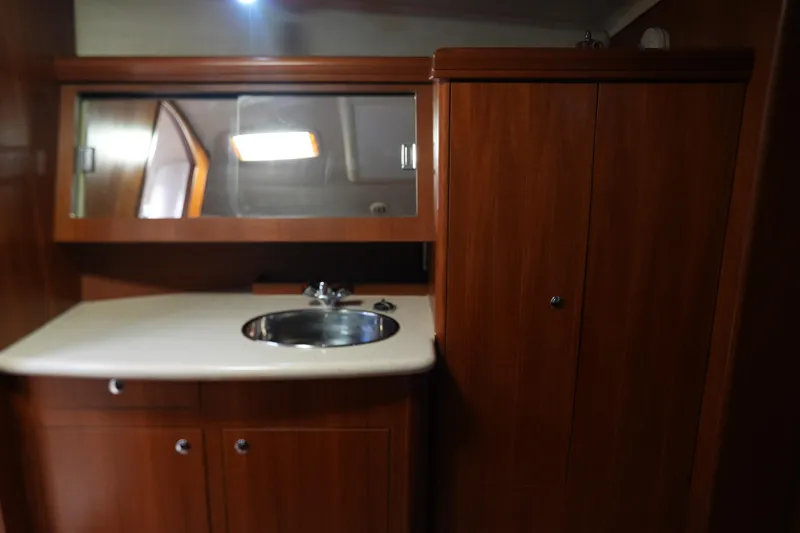 Marabelle Yacht Photos Pics Interior of 2005 Hunter 41 AC yacht with wooden cabinetry and sink.