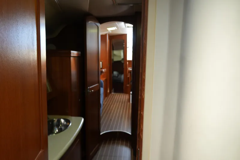 Marabelle Yacht Photos Pics Interior view of 2005 Hunter 41 AC yacht, featuring wooden cabinetry and hallway.