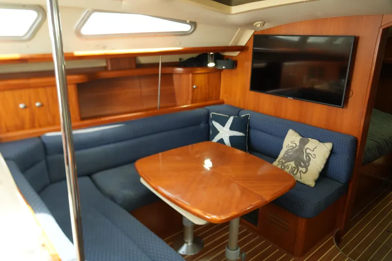 Marabelle Yacht Photos Pics Interior of 2005 Hunter 41 AC yacht with cozy seating and wooden table.