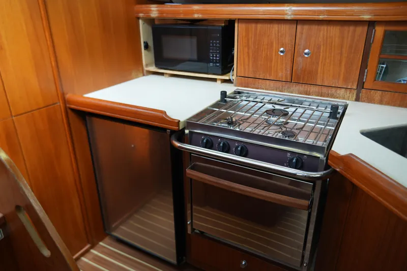 Marabelle Yacht Photos Pics Galley kitchen in 2005 Hunter 41 AC yacht with stove, fridge, and microwave.