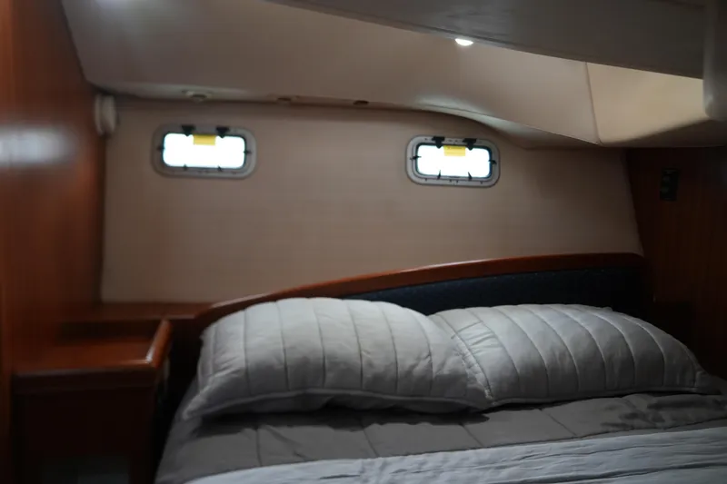 Marabelle Yacht Photos Pics Cozy cabin interior of 2005 Hunter 41 AC sailboat with bed and portholes.