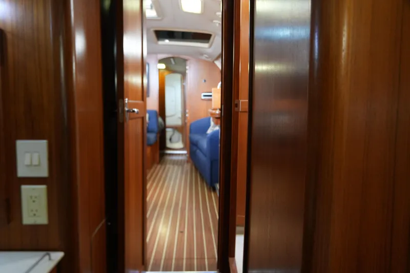 Marabelle Yacht Photos Pics Interior view of 2005 Hunter 41 AC sailboat with wooden finish and blue seating.