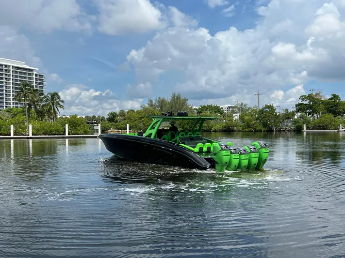  Yacht Photos Pics Sleek 2020 Midnight Express boat with vibrant green accents on a calm waterway.