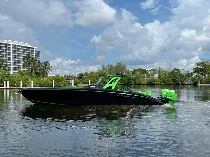  Yacht Photos Pics Midnight Express 2020 boat with green accents on a calm waterway.