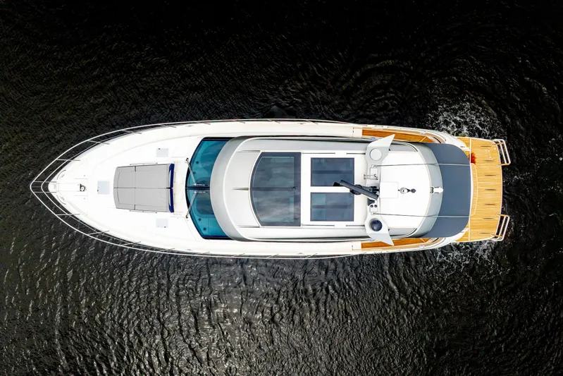  Yacht Photos Pics Overhead view of 2026 Riviera 6000 Sport Yacht cruising on water.