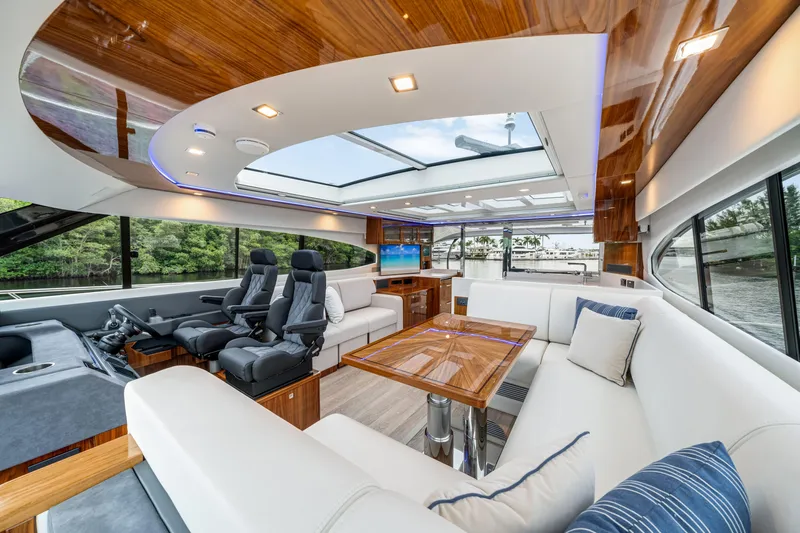  Yacht Photos Pics Luxurious interior of 2026 Riviera 6000 Sport Yacht with plush seating and modern design.