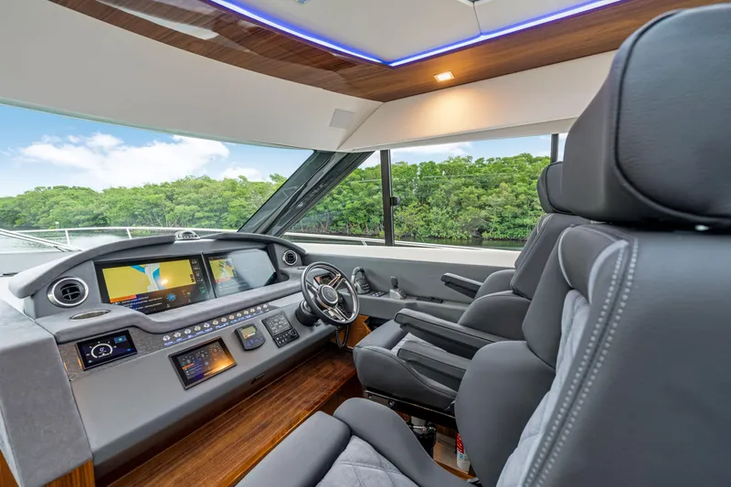  Yacht Photos Pics 2026 Riviera 6000 Sport Yacht helm with modern controls and luxurious seating.