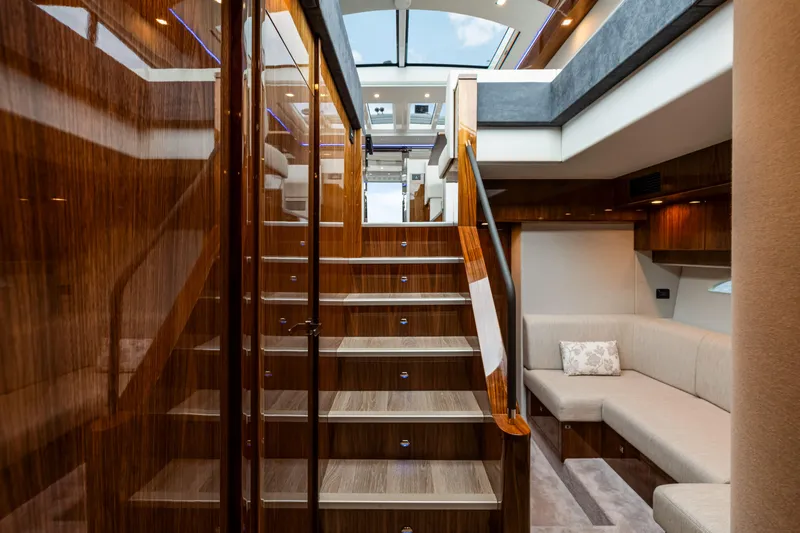  Yacht Photos Pics Luxurious interior of 2026 Riviera 6000 Sport Yacht with elegant wood finishes and modern design.