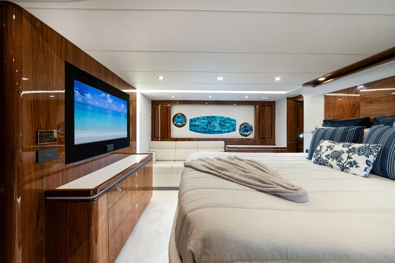  Yacht Photos Pics Luxurious interior of 2026 Riviera 6000 Sport Yacht with elegant wood finishes and modern decor.