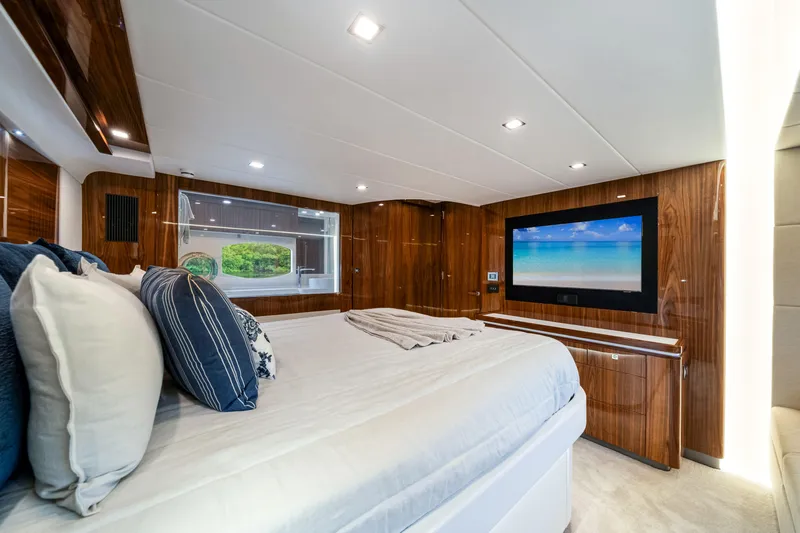  Yacht Photos Pics Luxurious bedroom interior of 2026 Riviera 6000 Sport Yacht with modern amenities.