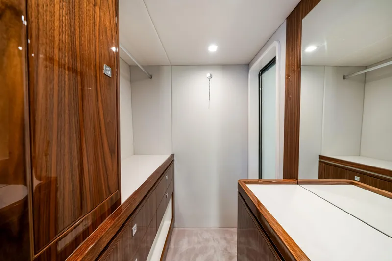  Yacht Photos Pics Luxurious interior of 2026 Riviera 6000 Sport Yacht with elegant wood finishes.